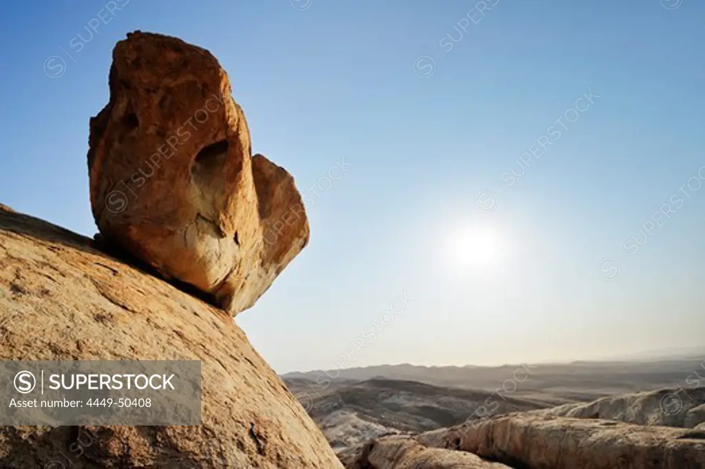 Rock laying on steep slab, Blutkoppe, Namib Naukluft National Park, Namib desert, Namib, Namibia
