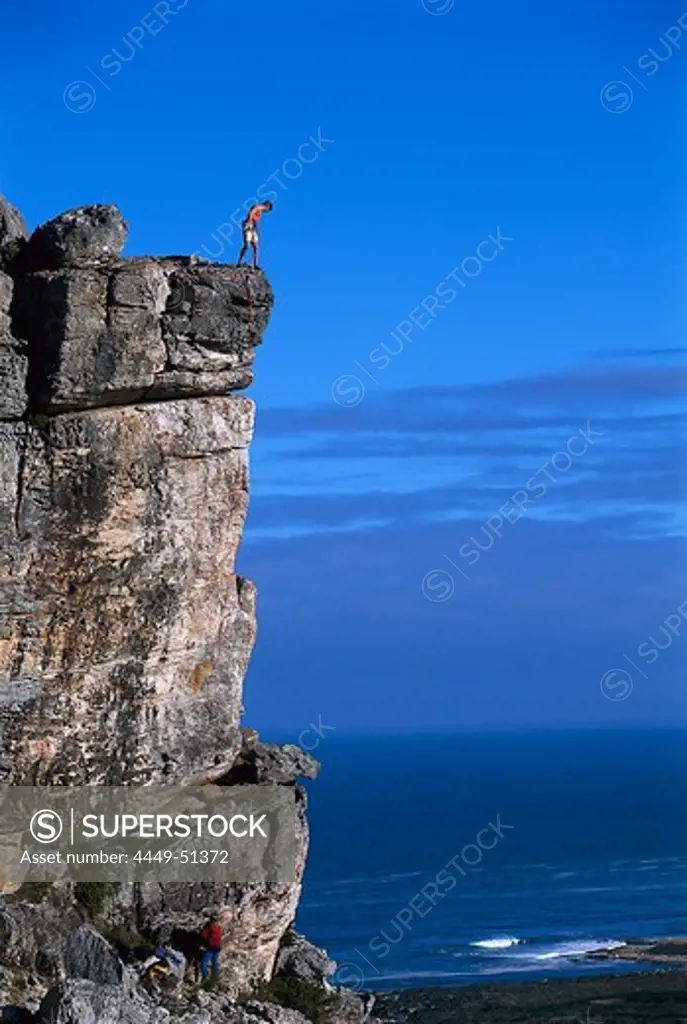 A group of rock climbers climbing, Kleinmond, South Africa