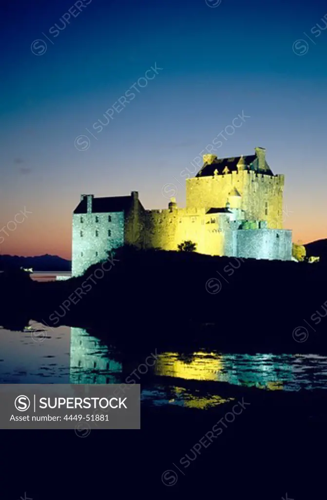 The illuminated Eilean Donan castle at night, Ross and Cromarty, Highlands, Scotland, Great Britain, Europe