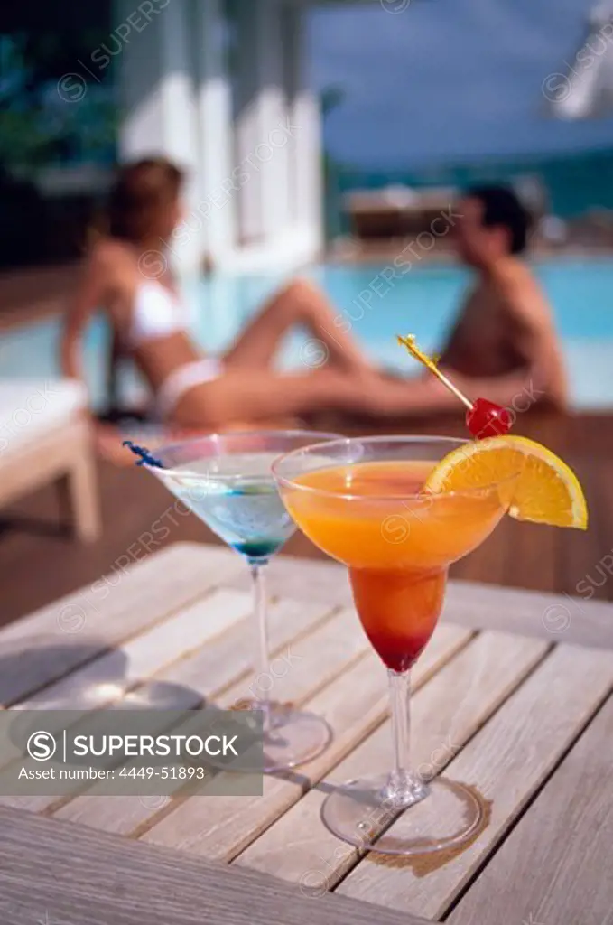 A couple sat behind a refreshing cocktail at the pool of Casa Colonial Beach and Spa, the Playa Dorada, Puerto Plata, Dominican Republic, Caribbean