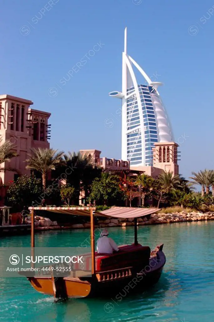 A boat on the canal and the Burj al Arab hotel, Dubai, United Arab Emirates, Middle East, Asia