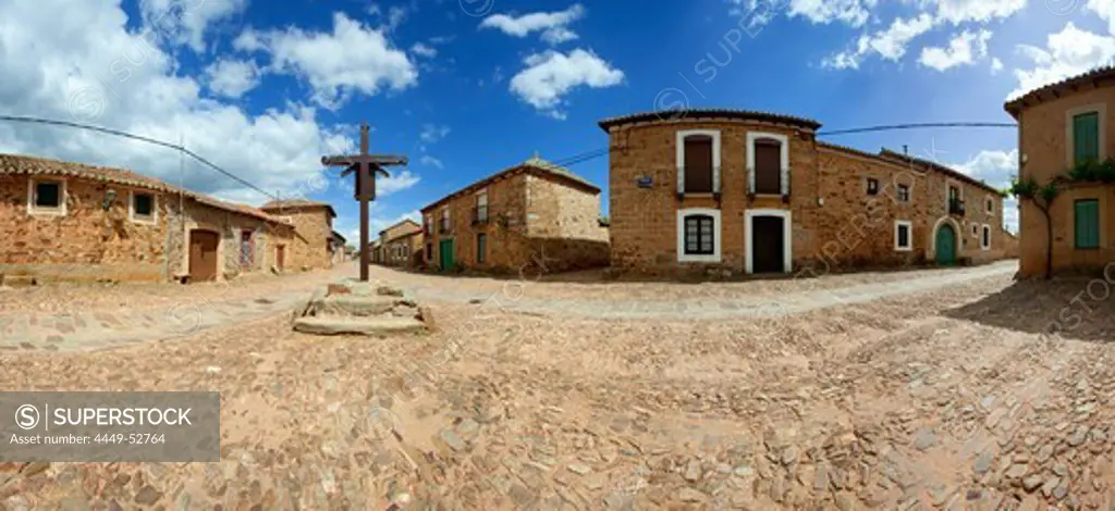 Houses and cross at the village of Castrillo de los Polvazares, Province of Leon, Old Castile, Castile-Leon, Castilla y Leon, Northern Spain, Spain, Europe