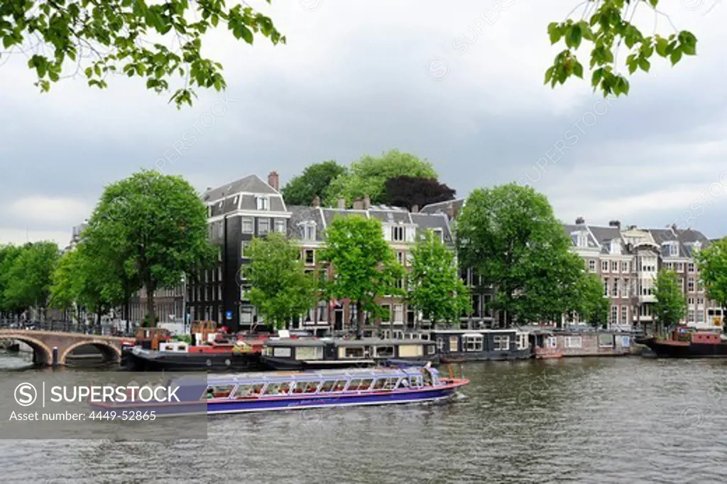 Excursion boat, residential houses along the Amstel river, Amsterdam, the Netherlands, Europe