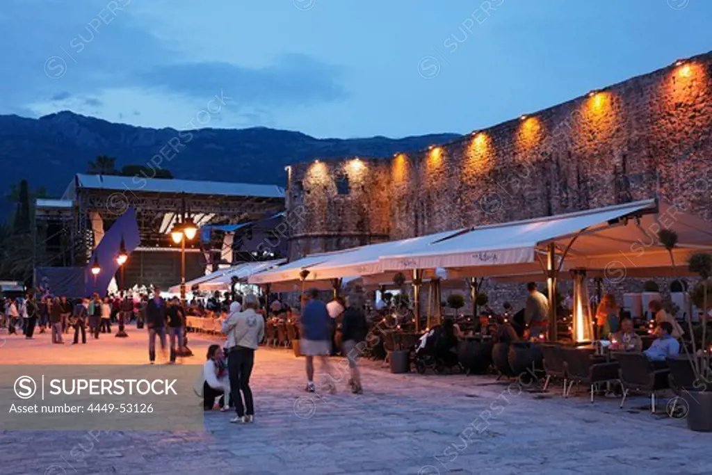 Restaurants along the city wall in the evening, Budva, Montenegro, Europe