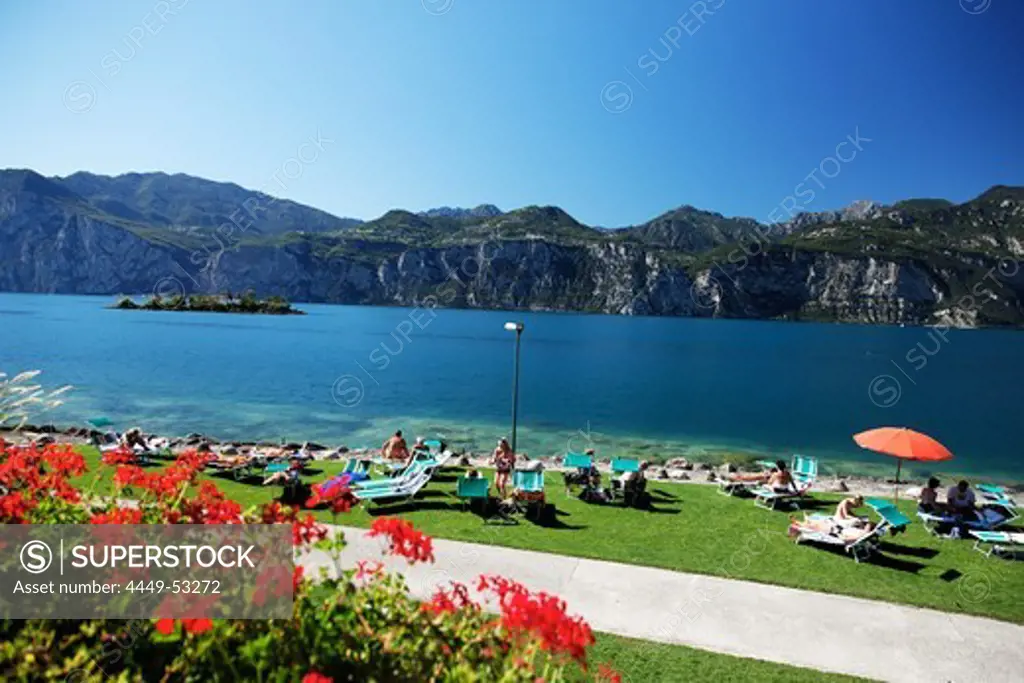 People sunbathing, Malcesine, Lake Garda, Veneto, Italy