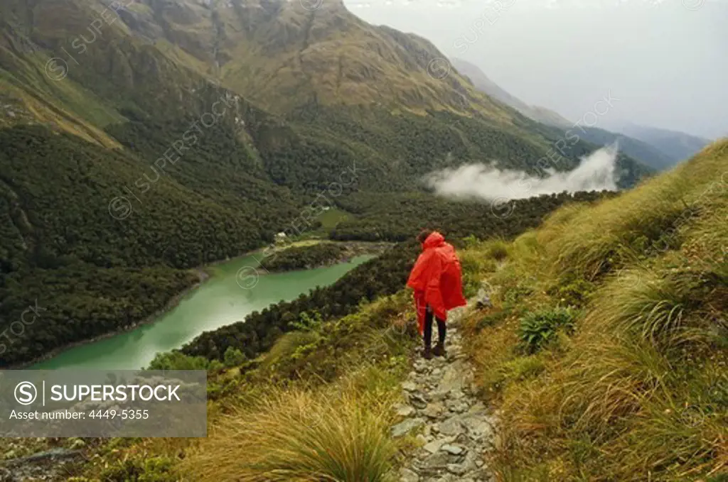 Hiker on Routeburn Track looking onto Lake Mackenzie, Mount Aspiring National Park, New Zealand, Oceania