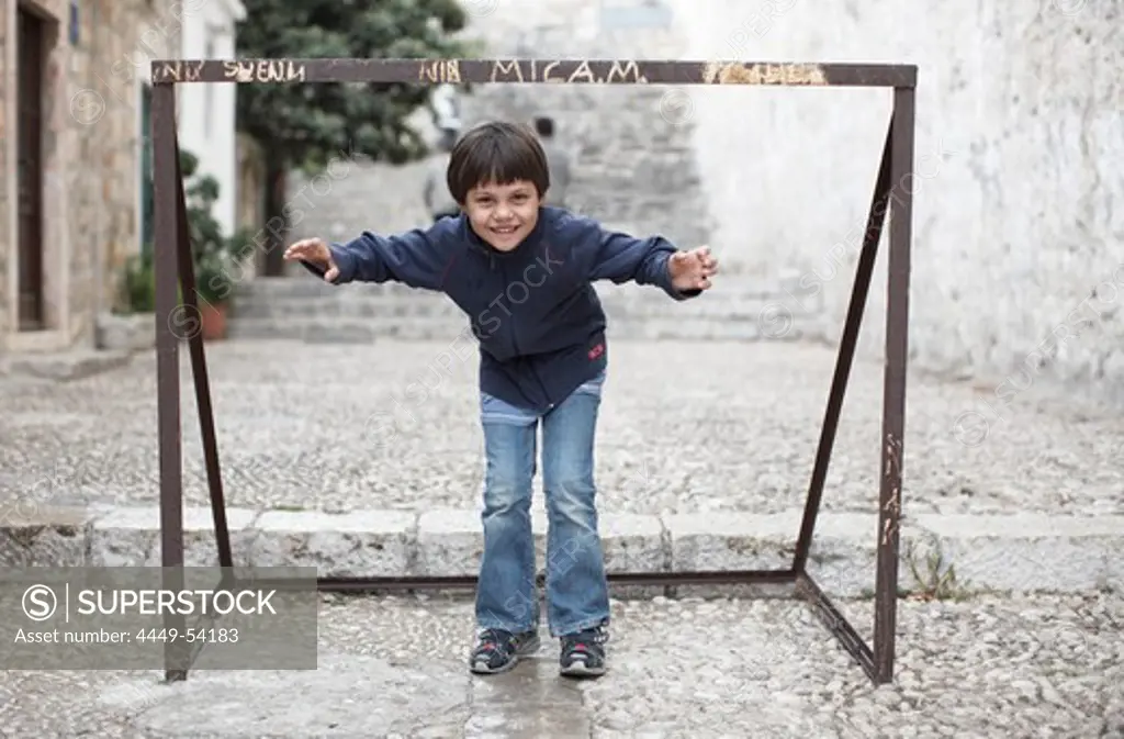 Boy (8 years) playing goalkeeper Dubrovnik, Dalmatia, Croatia