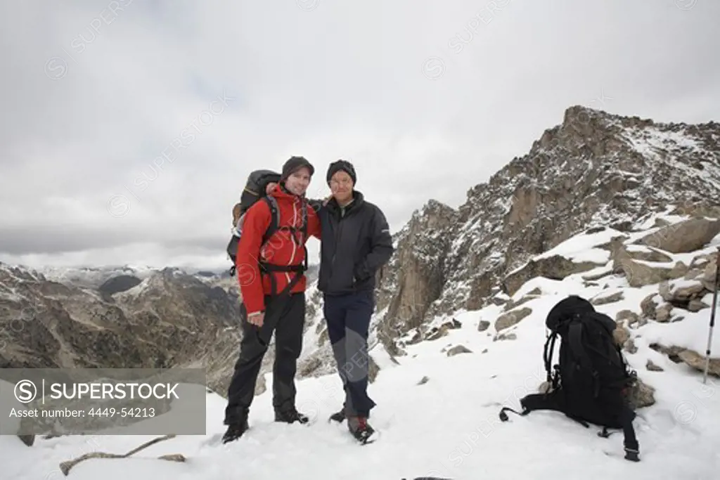 Two hikers on Pass Coll de Monastero, Carros de Foc, Aiguestortes i Estany de Sant Maurici National Park, Catalonia, Spain