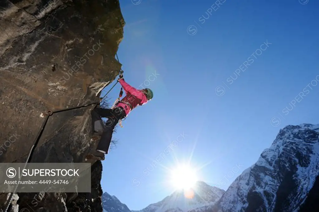 Woman climbing overhang in fixed rope route, Schiestl-via ferrata, fixed rope route, Laengenfeld, valley of Oetztal, Oetztal range, Tyrol, Austria, Europe