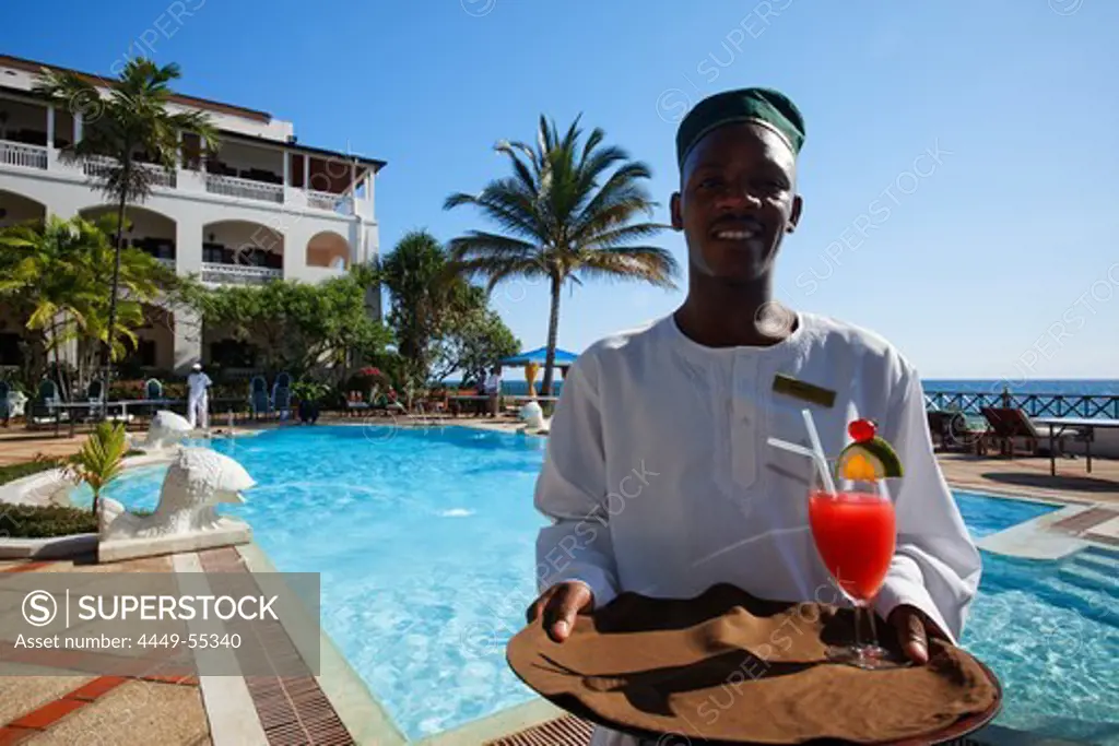 Waiter at the pool in front of Serena Inn hotel, Stonetown, Zanzibar City, Zanzibar, Tanzania, Africa
