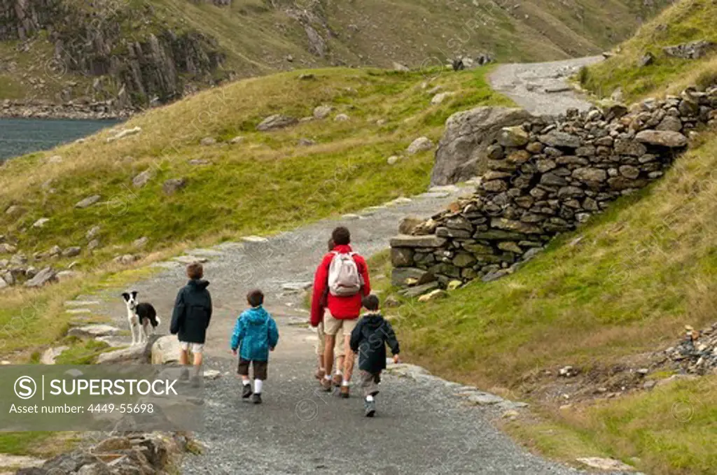 Family walking the Miners Track towards Mt. Snowdon, Snowdonia National Park, Wales, UK
