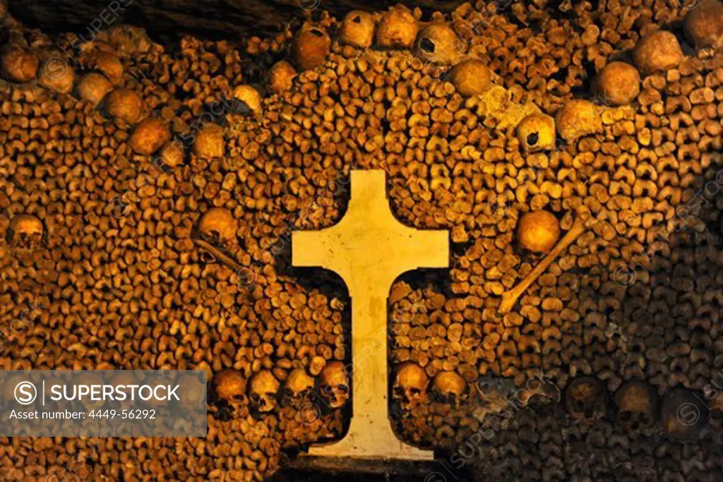 Pile of bones and cross in the catacombs, Paris, France, Europe