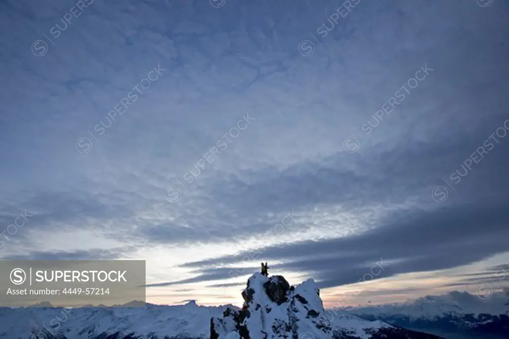 Snowboarder standing on a mountain in twilight, Chandolin, Anniviers, Valais, Switzerland