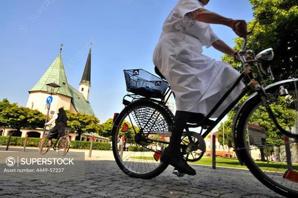 Cyclists at suqare Kapellplatz, Altoetting, Bavaria, Germany, Europe