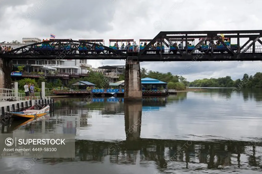 Tourist train crosses the Bridge over the River Kwai, Kanchanaburi, Thailand