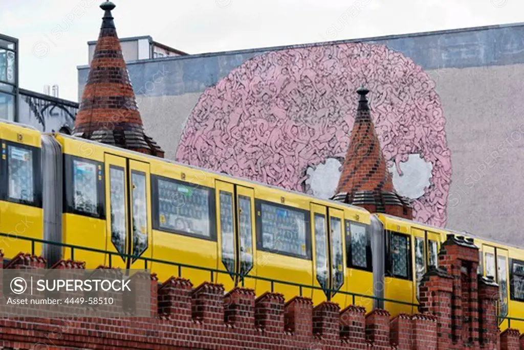 Suburban Train with a Graffiti in the background, Oberbaum Bridge, Friedrichshain, Berlin, Germany