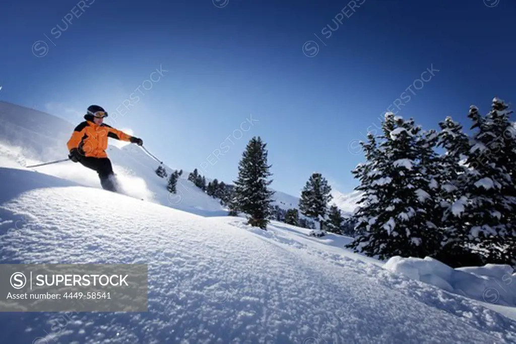 Skier sking down fresh new snow at Hohen Mut, Obergurgl, Tyrol, Austria