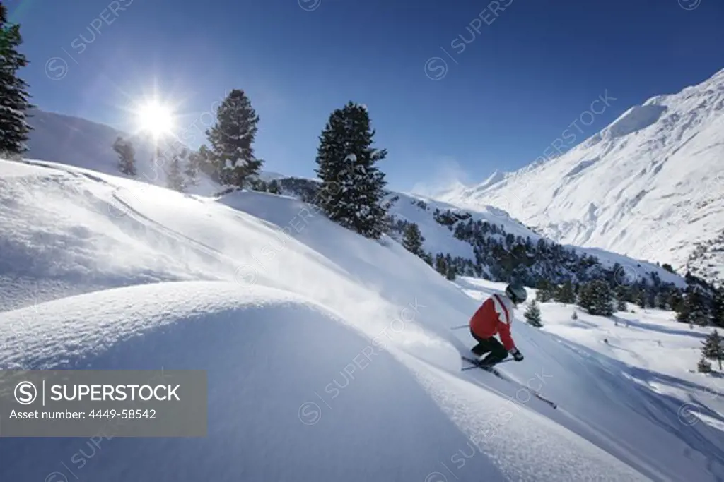Skier sking in fresh new snow at hohen Mut, Obergurgl, Tyrol, Austria