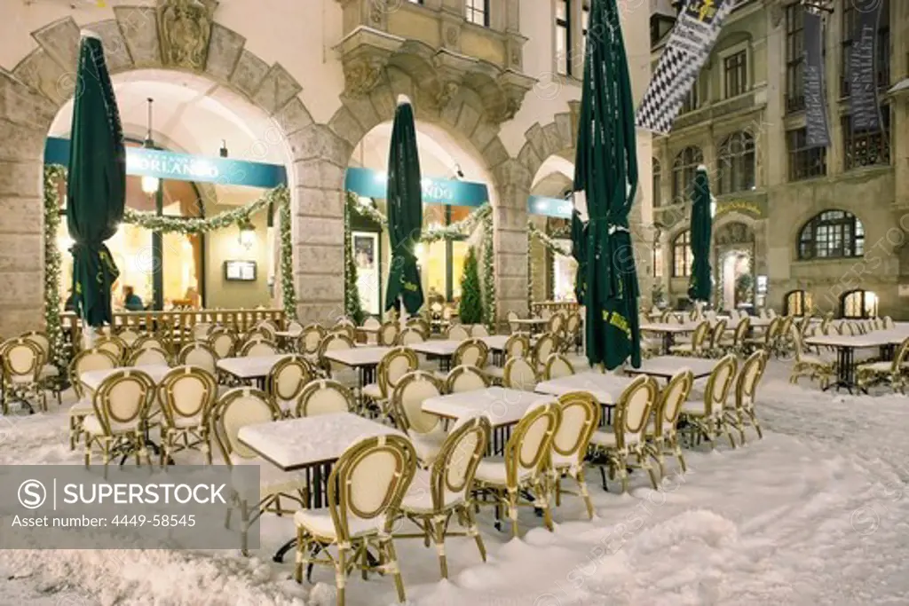 Snow covered chairs and tables outside Orlando, Platzl, Munich, Bavaria, Germany