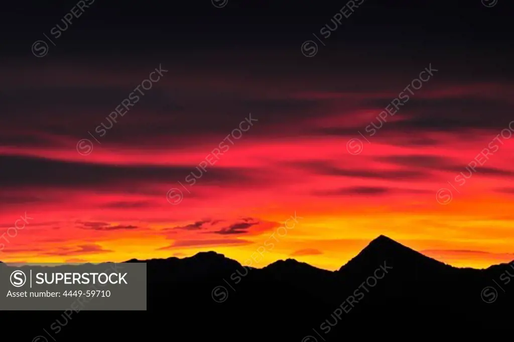 Clouds above silhouettes of Untersberg and Sonntagshorn in the afterglow, view from Lacherspitze, Wendelstein range, Bavarian alps, Upper Bavaria, Bavaria, Germany, Europe