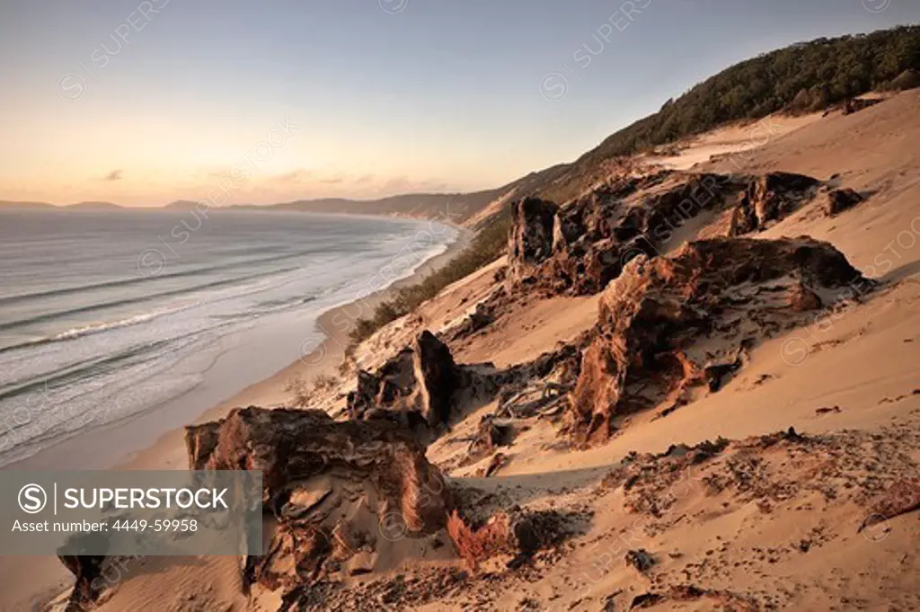 Sand dunes and rocks at Rainbow Beach at sunrise, Fraser Island, UNESCO World Nature Site, Southern Pacific, Queensland, Australia