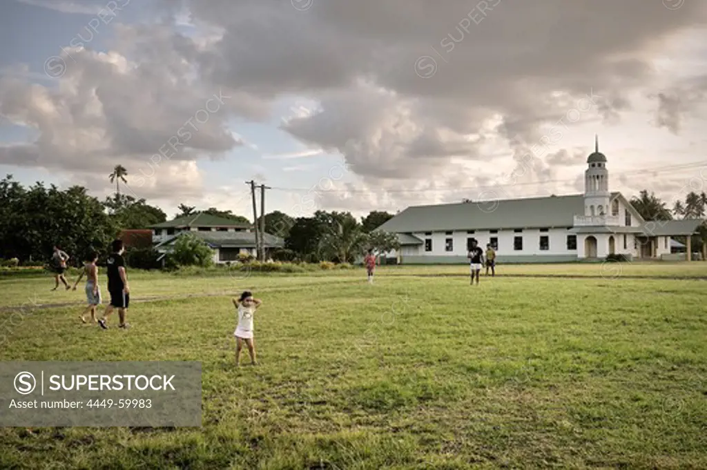 Locals play rugby in front of a church, typical village lifestyle, Apia, Upolu, Samoa, Southern Pacific island