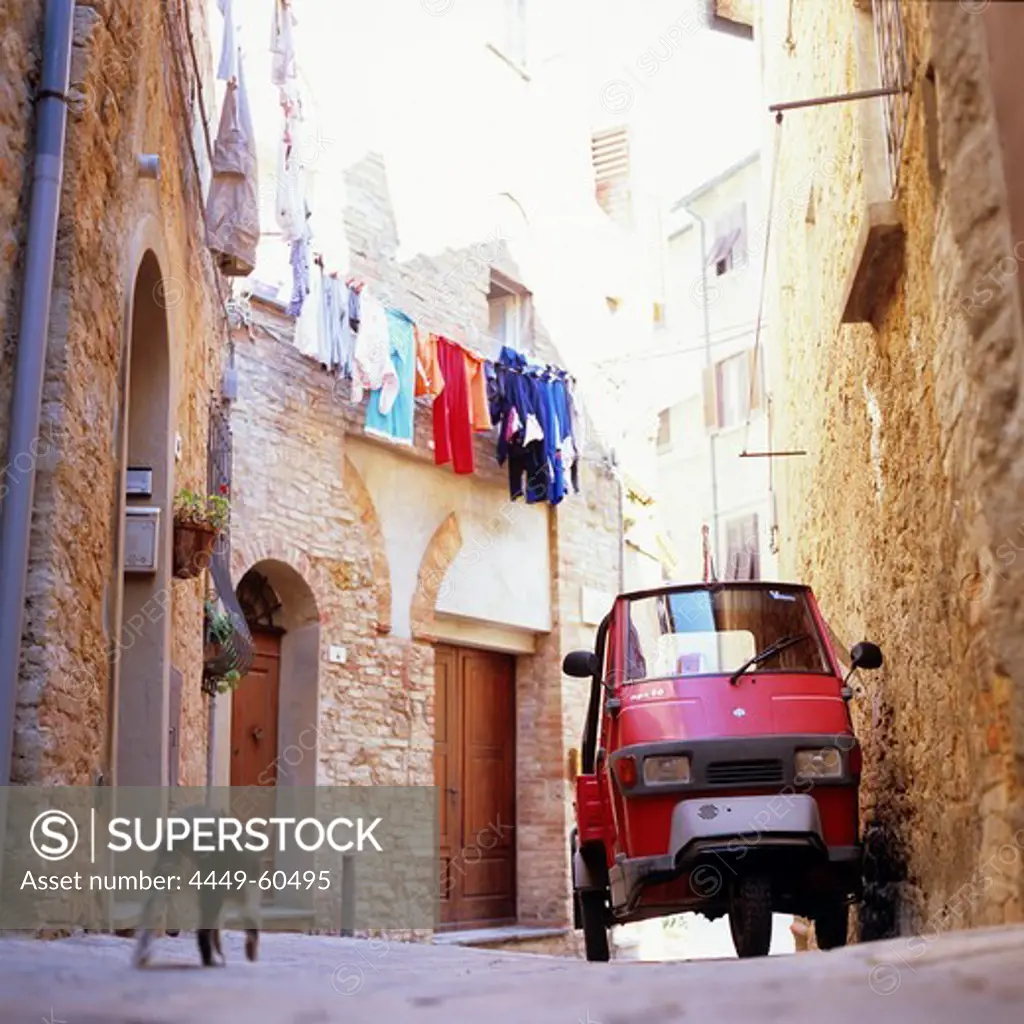 Small car standing in a narrow alley, Montepulciano, Tuscany, Italy