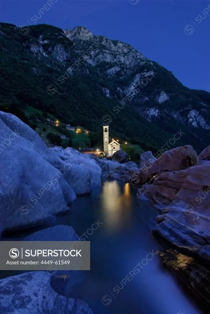 River Verzasca in twilight with illuminated church of Lavertezzo, valley of Verzasca, Verzasca, Ticino, Switzerland