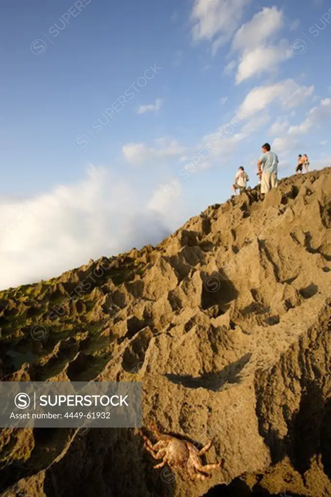 People and a crab climbing over rocks, Punta Borinquen, Aguadilla, Puerto Rico, Carribean, America