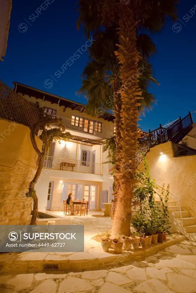 A person sitting on the patio relaxing, Traditional guest house with palm tree, Cyprus Villages Traditional Houses Ltd, agrotourism, Kalavasos, near Limassol, Cyprus