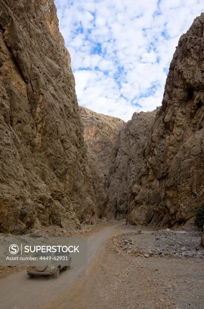 4x4 jeep driving through a canyon, dirt road, mountain landscape, Hajjar mountains, Musandam, Oman