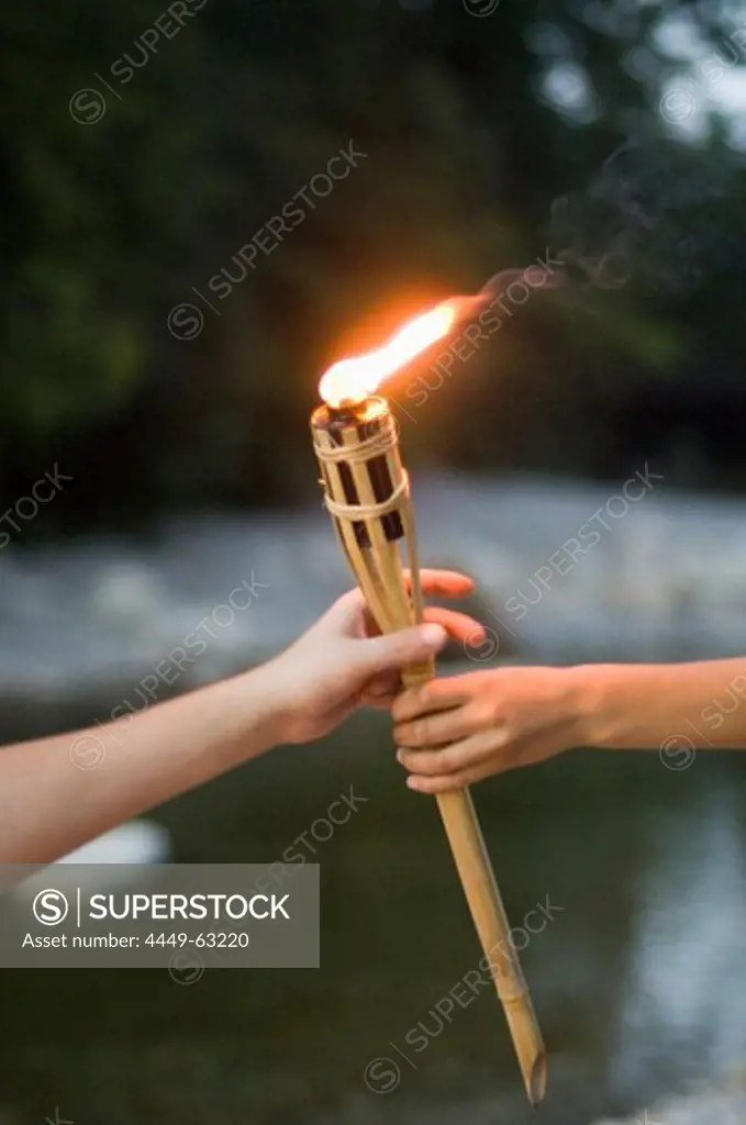 Hands holding torch