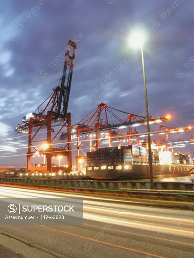 Container cranes at container port in the night, Hamburg, Germany