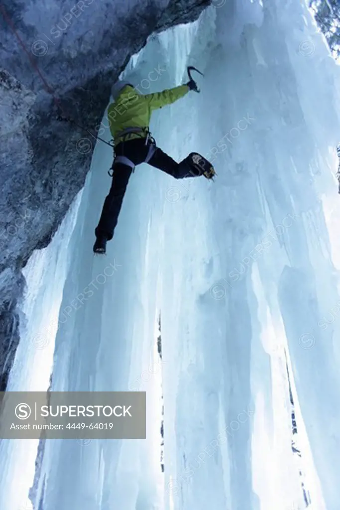 Iceclimber climbing on an ice face, Immenstadt, Bavaria, Germany