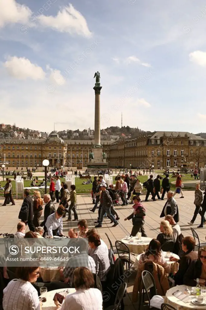 People in a sidewalk cafe, view at the New Castle with Jubilaeumssaeule, Palace Square, Stuttgart, Baden-Wurttemberg, Germany