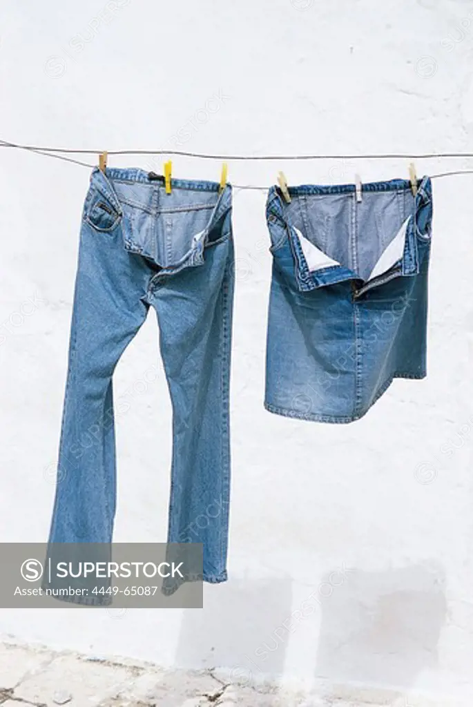 Jeans trousers and jeans skirt drying on clothesline, Bavaria, Germany