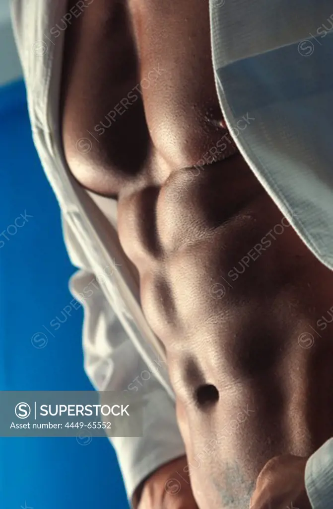 Muscular belly under opened shirt