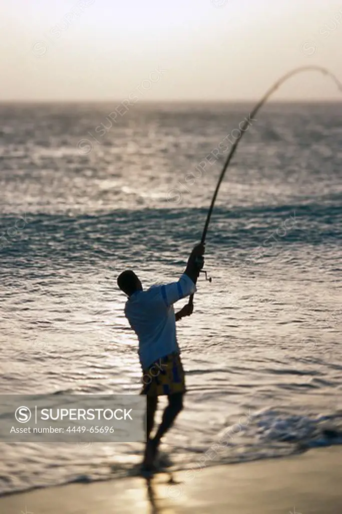 Man is fishing at the beach of Sáo Pedro, Sáo Vicente, Cape Verde, Africa