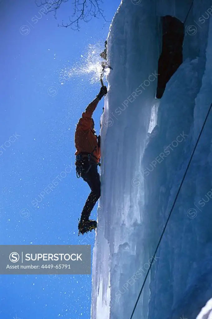 A man climbing up an ice face