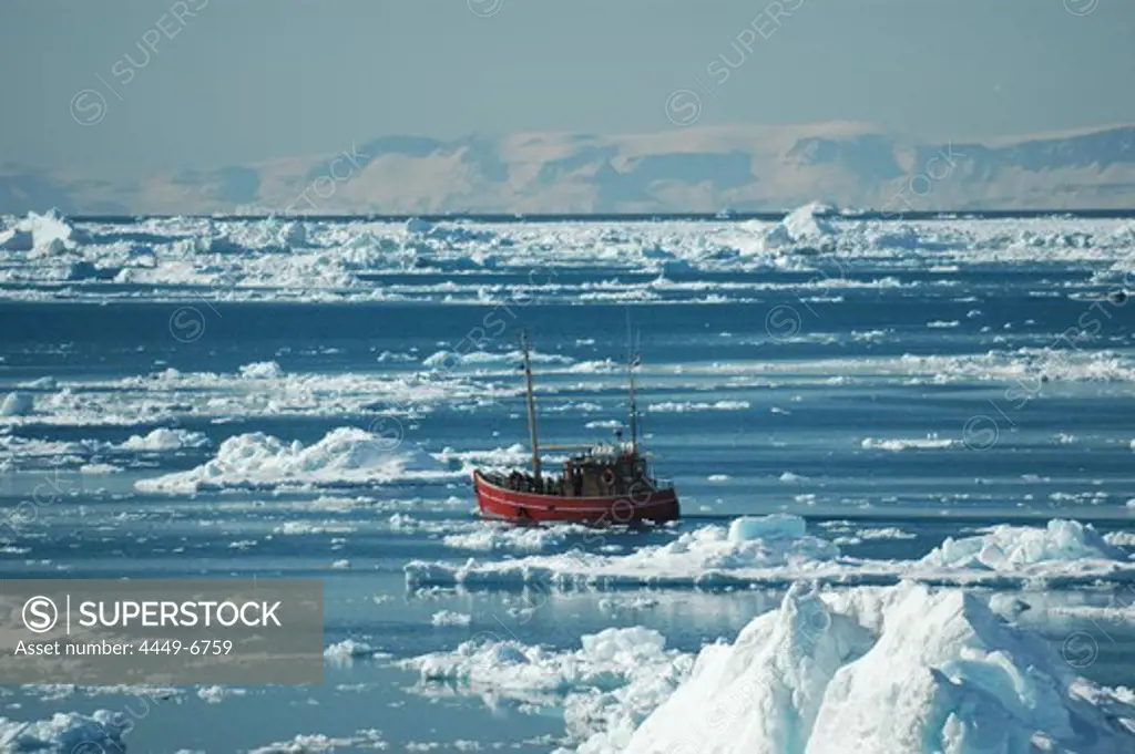 Fishing boat amongst icebergs, Ilulissat, Jakobshavn, Kaalalit Nunaat, Greenland
