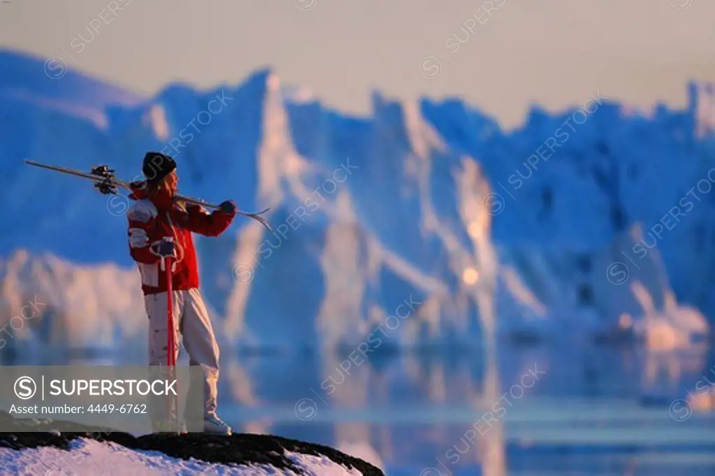 Woman carrying skis, admiring the view, Skiing, Ilulissat, Greenland