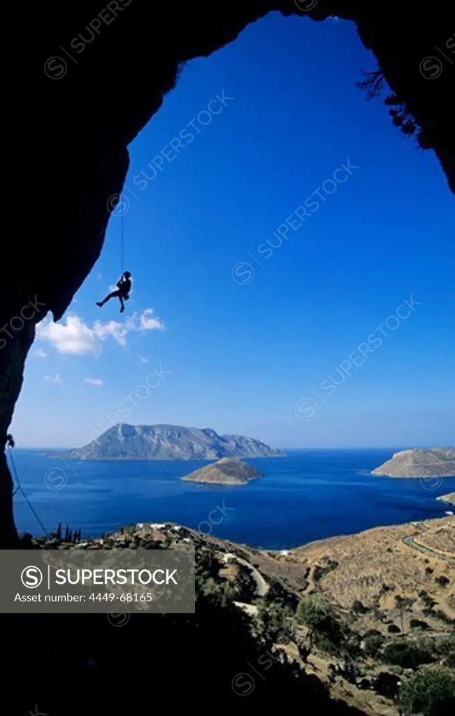 Kalymnos, Greece, Aegean Sea, a climber abseils in a cave above the sea. Kalymnos, Greece, Aegean Sea, Europe