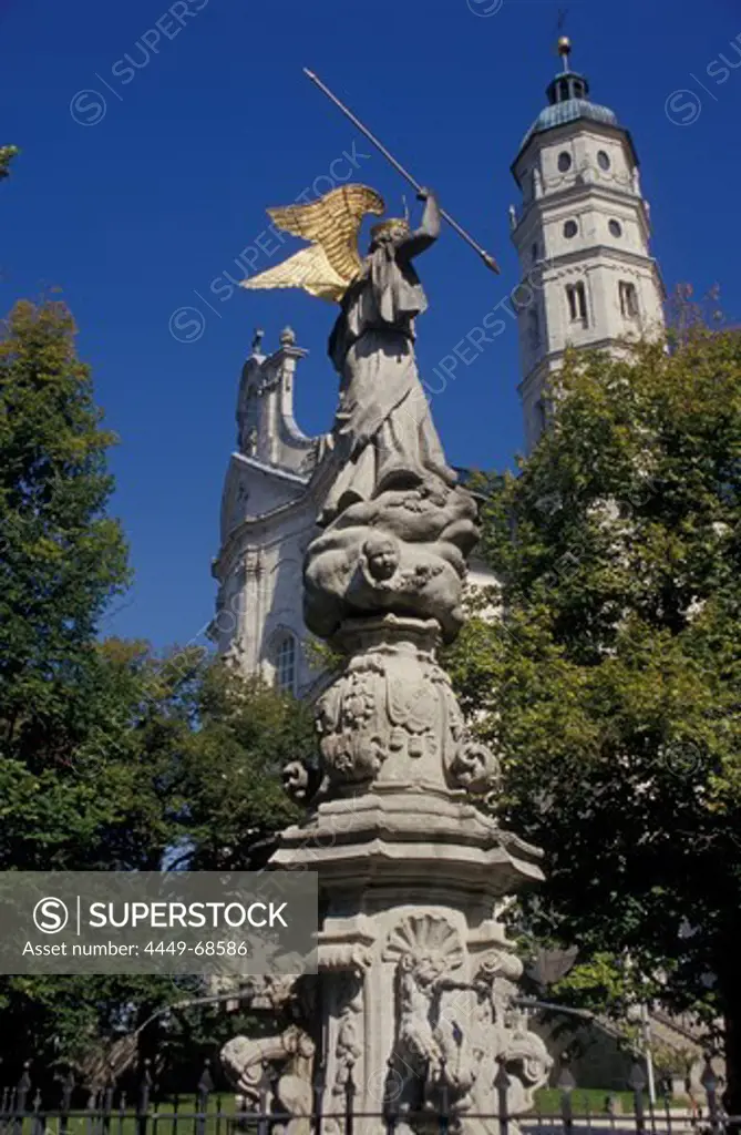 Statue in front of abbey church under blue sky, Neresheim, Baden-Wuerttemberg, Germany, Europe