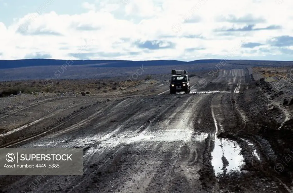 Car on road in lonesome landscape, Rio Mayo, Argentina, South America, America