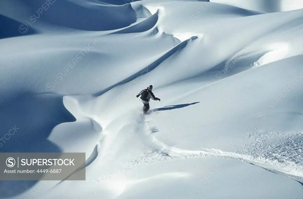 Snowboarder in deep snow, Valluga, Arlberg, Tyrol, Austria, Europe