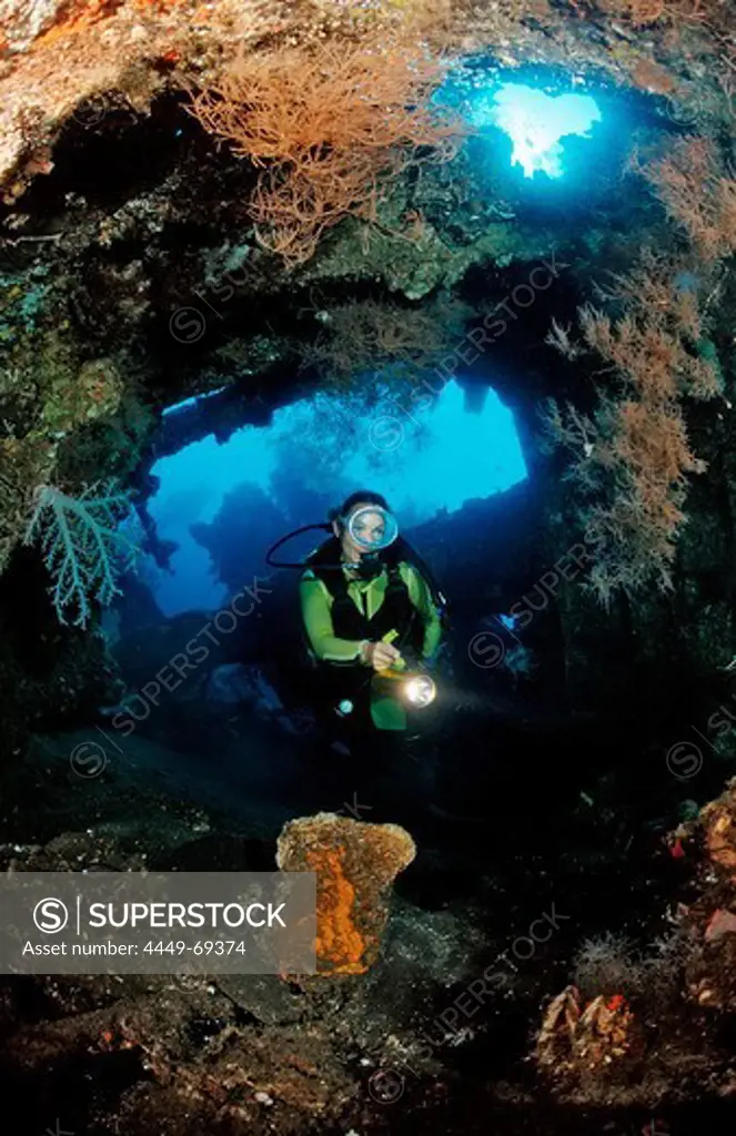 Scuba diver examines ship wreck Liberty, Indonesia, Bali, Tulamben, Indian Ocean