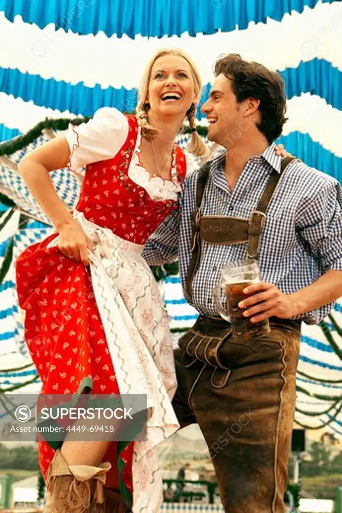 Couple dancing on table in a beer tent