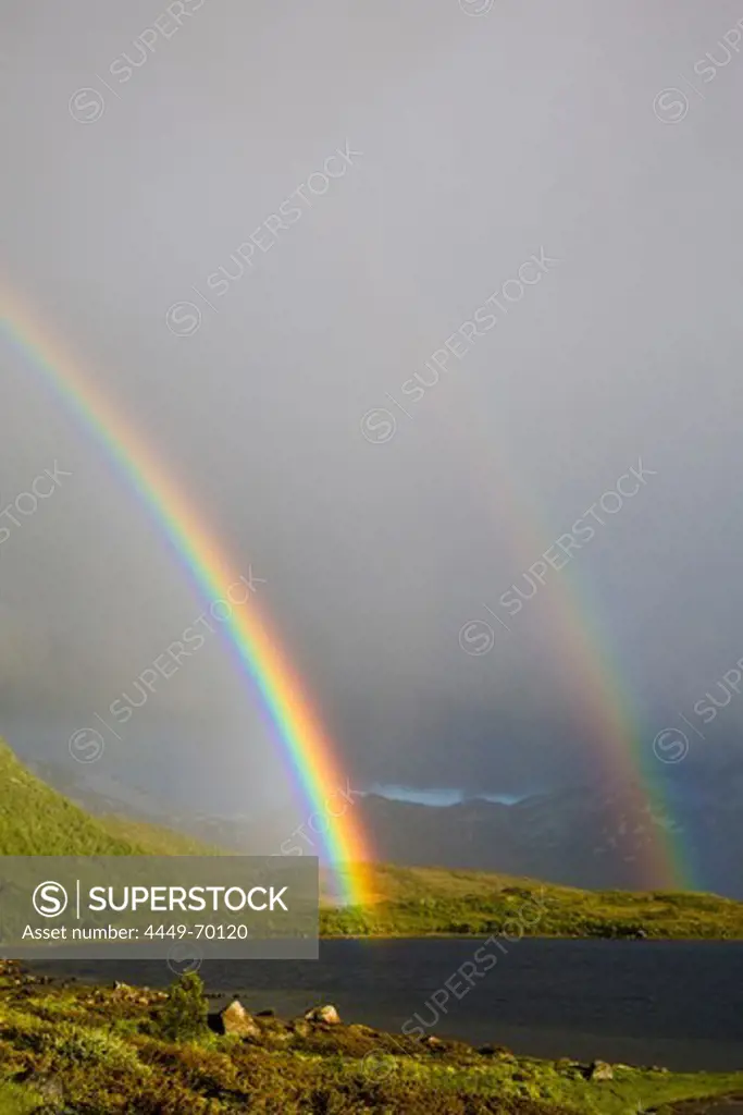 A double rainbow, two rainbows with rain shower and sunshine, Sandsletta, Austvagoya Island, Lofoten, Norway