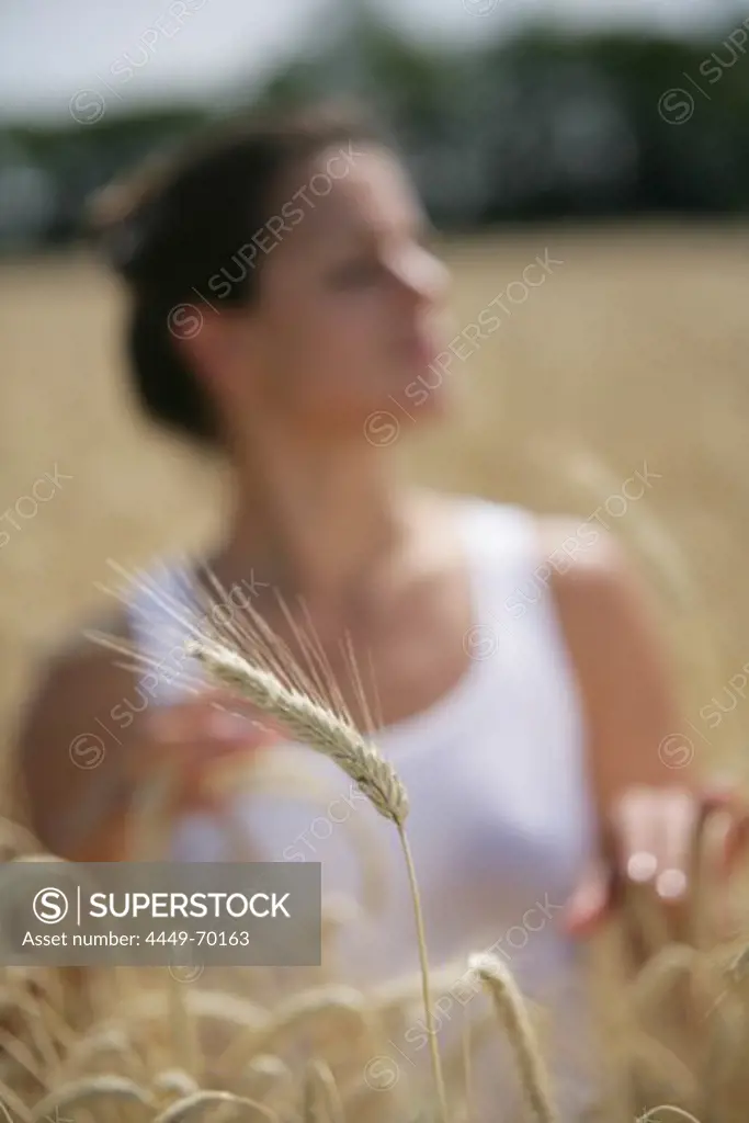 Mid adult woman standing in a corn field, Carinthia, Austria