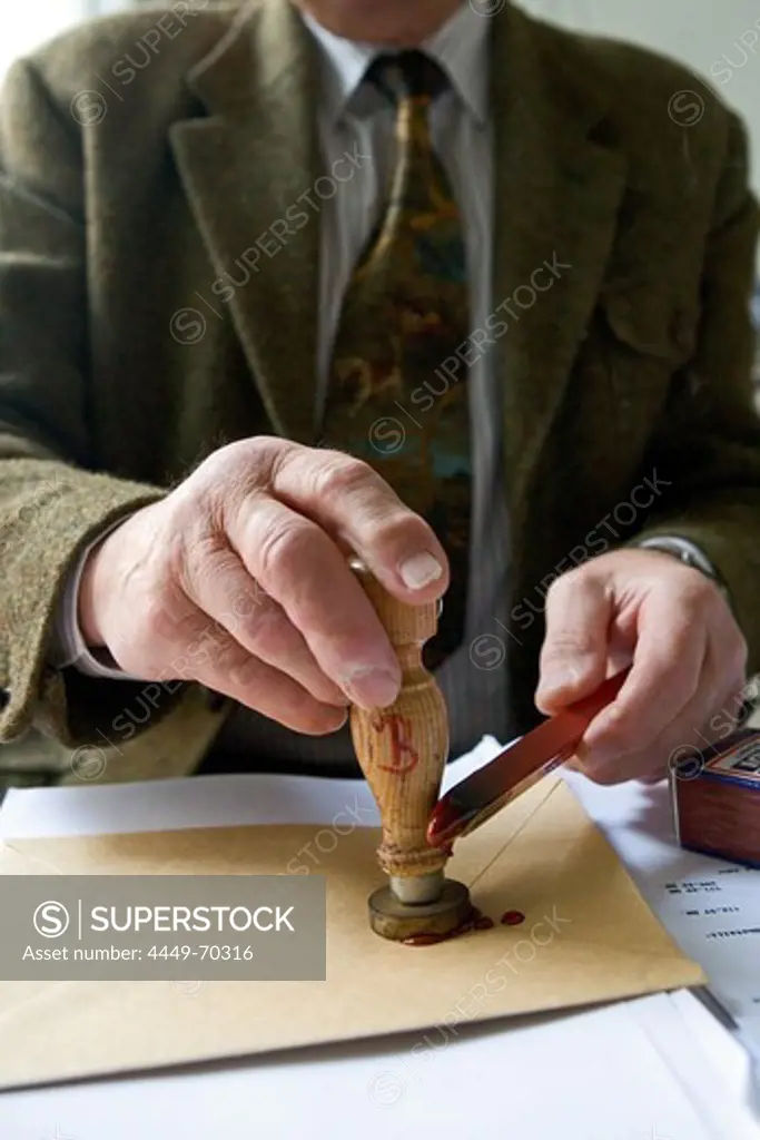 Notary fixes a seal on a document, last will and testament, inheritance seal, sealing wax
